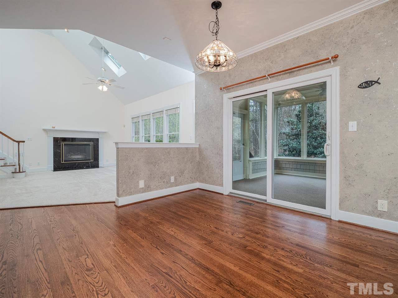 206 Chiselhurst Way Cary, NC 27513 - Photo 16 of 30 a view of empty room with wooden floor and fireplace