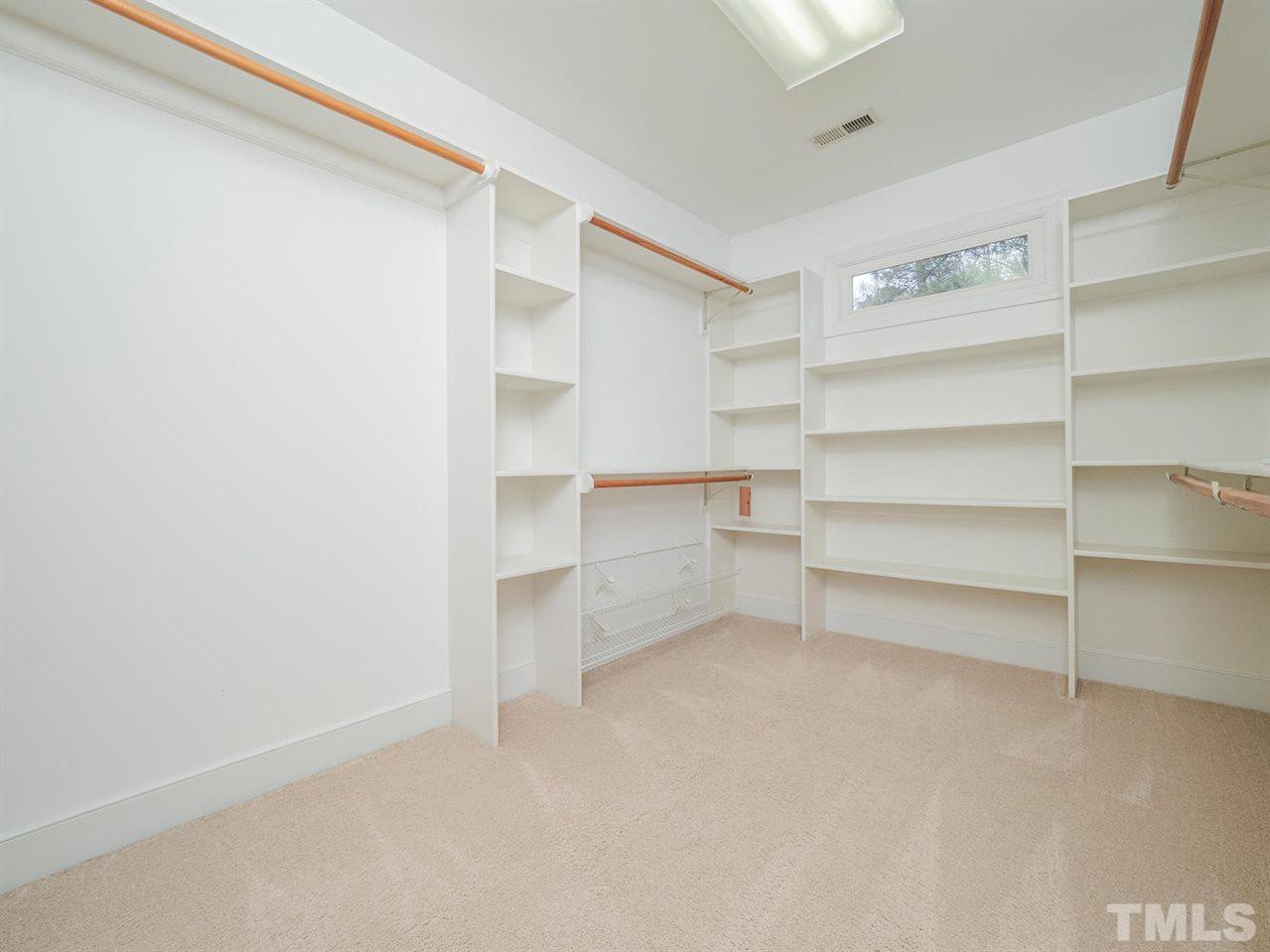 206 Chiselhurst Way Cary, NC 27513 - Photo 19 of 30 a view of walk in closet with empty racks