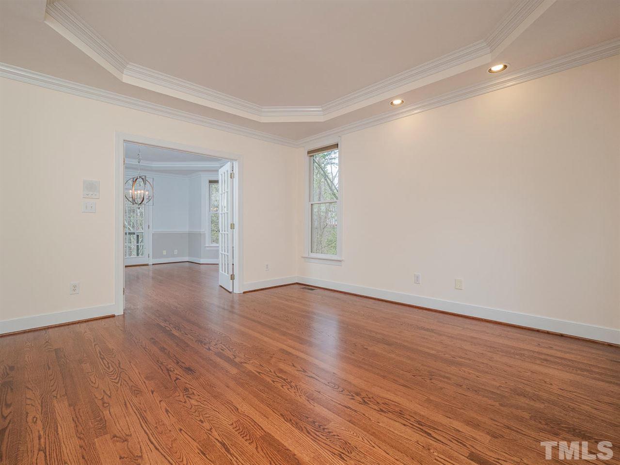 206 Chiselhurst Way Cary, NC 27513 - Photo 22 of 30 a view of an empty room with wooden floor and a window