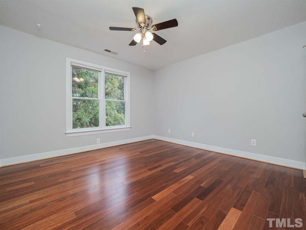 206 Chiselhurst Way Cary, NC 27513 - Photo 24 of 30 an empty room with wooden floor and windows
