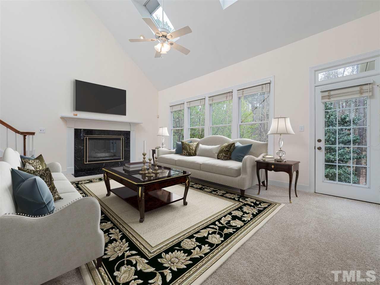 206 Chiselhurst Way Cary, NC 27513 - Photo 9 of 30 a living room with furniture a flat screen tv and a fireplace