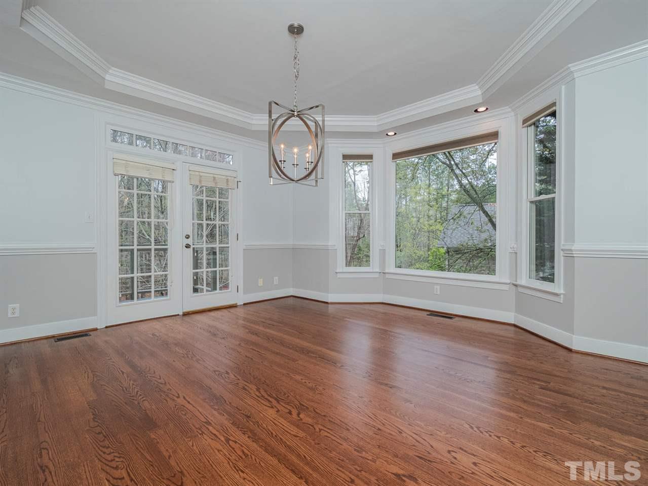 206 Chiselhurst Way Cary, NC 27513 - Photo 10 of 30 a view of empty room with wooden floor and fan
