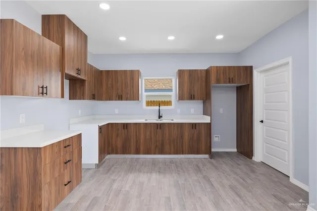 a kitchen with wooden cabinets and center island