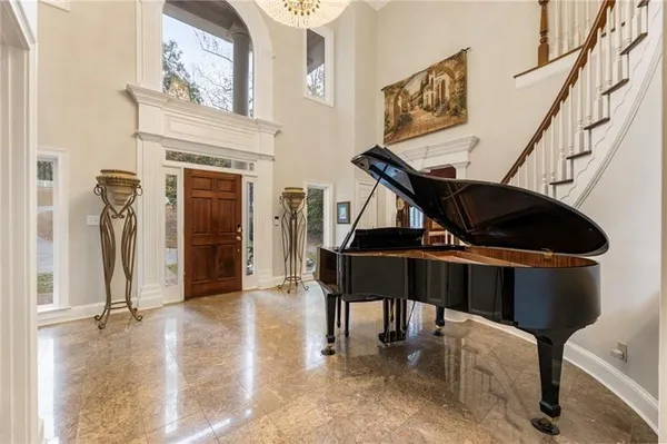 a kitchen with stainless steel appliances granite countertop a refrigerator a stove and a sink with wooden floors