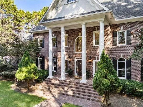 a living room with furniture a fireplace and a large window