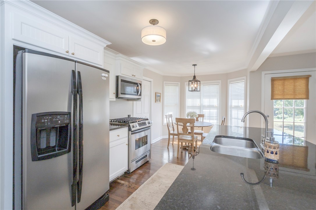 208 Mahaffey Road Williamston, SC 29697 - Photo 11 of 44 This bright kitchen features stainless steel appliances, granite countertops, and hardwood flooring.