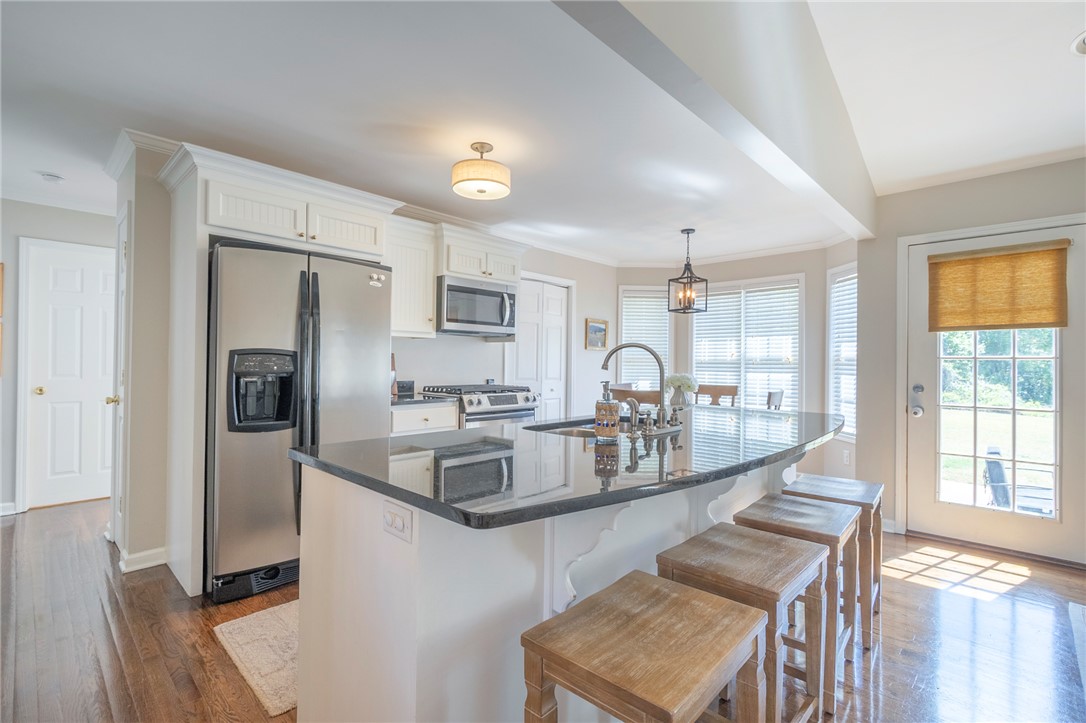 208 Mahaffey Road Williamston, SC 29697 - Photo 14 of 44 This kitchen features sleek stainless steel appliances, a spacious island with bar seating, and ample natural light.