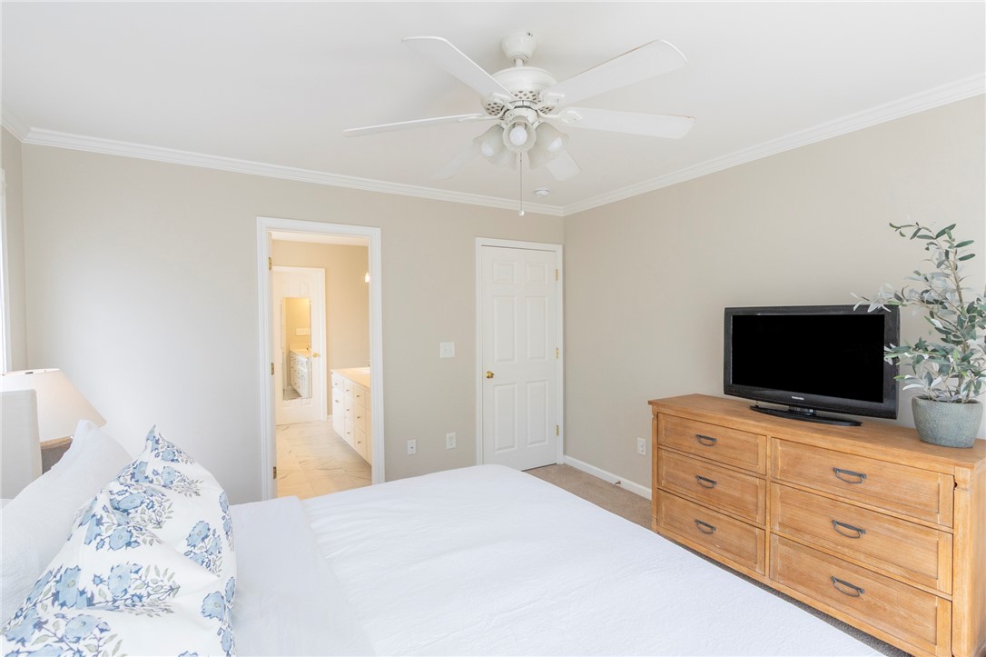 208 Mahaffey Road Williamston, SC 29697 - Photo 27 of 44 This primary bedroom features crown molding and a ceiling fan, offering a comfortable retreat.