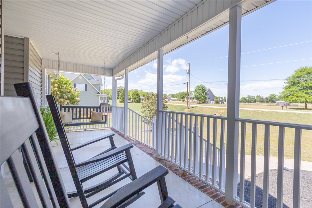 208 Mahaffey Road Williamston, SC 29697 - Photo 3 of 44 Relax on this inviting covered porch with ample space for rocking chairs and a swing.