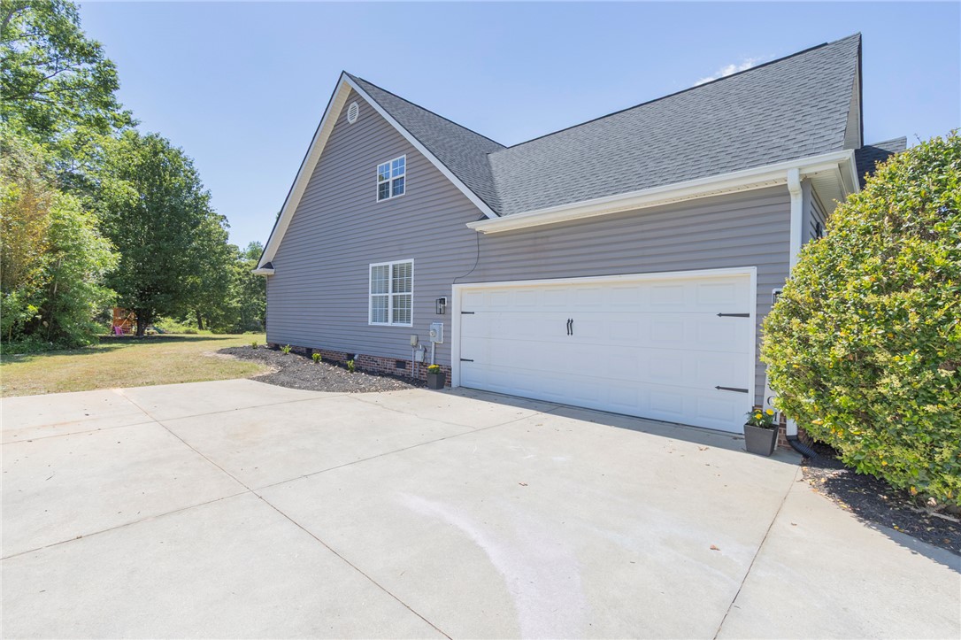 208 Mahaffey Road Williamston, SC 29697 - Photo 37 of 44 This residence features a convenient attached garage and a spacious driveway for ample parking.
