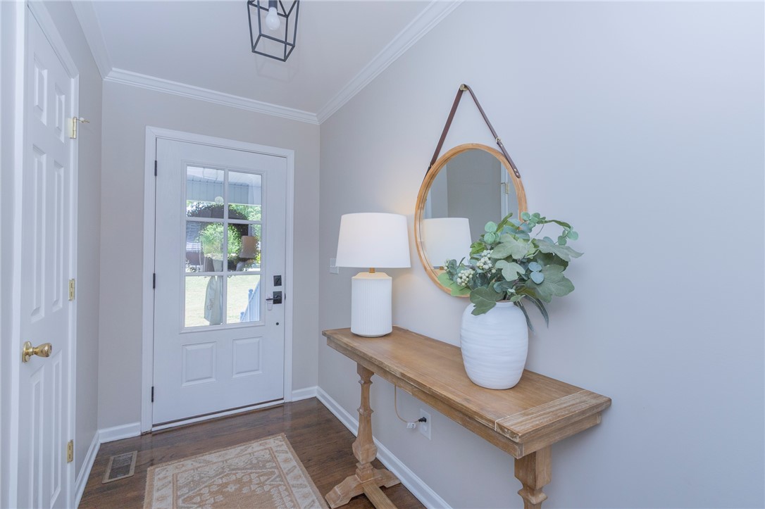 208 Mahaffey Road Williamston, SC 29697 - Photo 5 of 44 This inviting entryway features hardwood flooring and crown molding, setting a welcoming tone.