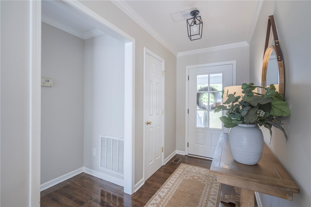 208 Mahaffey Road Williamston, SC 29697 - Photo 6 of 44 This inviting entryway features rich hardwood floors and a bright, welcoming door.