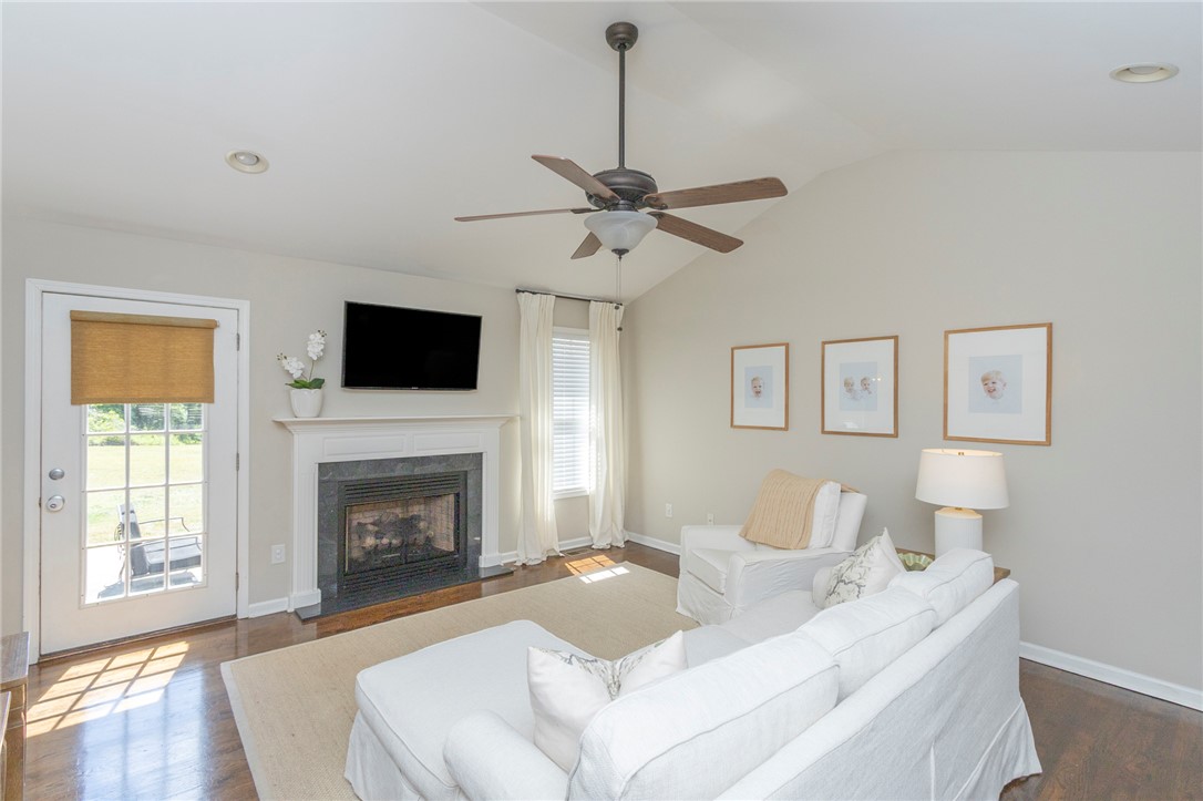 208 Mahaffey Road Williamston, SC 29697 - Photo 7 of 44 This bright living area features vaulted ceilings and a cozy fireplace, creating an inviting atmosphere.
