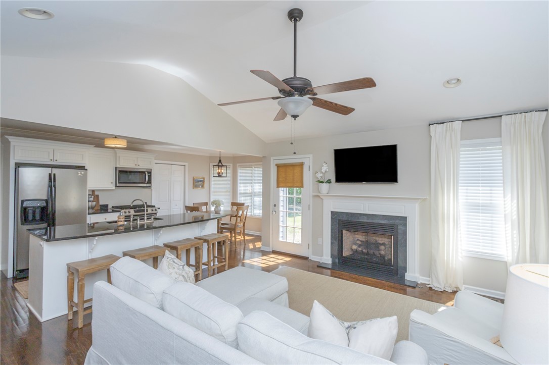208 Mahaffey Road Williamston, SC 29697 - Photo 8 of 44 Bright, open-concept living space with a fireplace and convenient kitchen access.