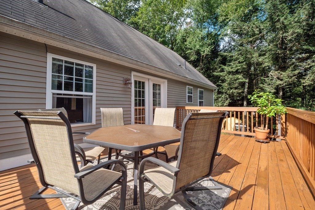 87 Cummington Road Chesterfield, MA 01084 - Photo 3 of 33 a view of a patio with table and chairs with wooden floor and fence