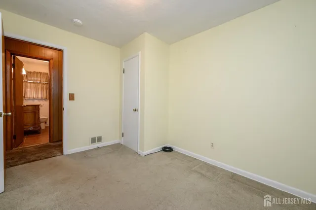 an empty room with closet area
