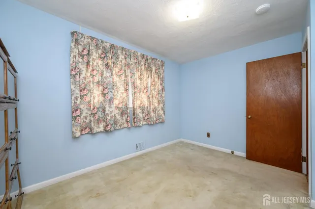 a view of room with window and hallway