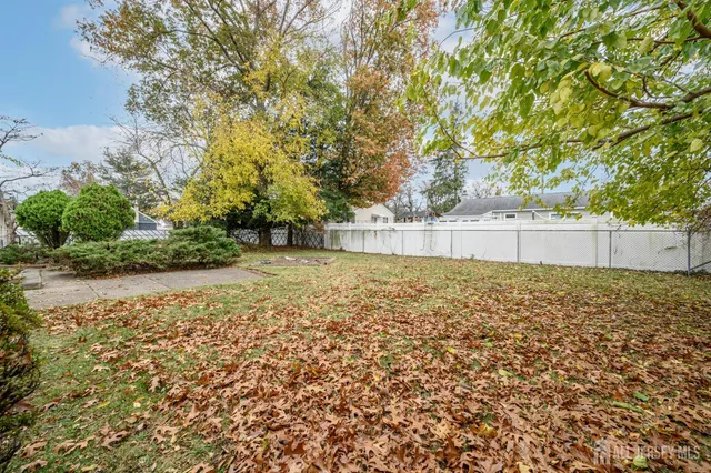 a view of a backyard with large trees