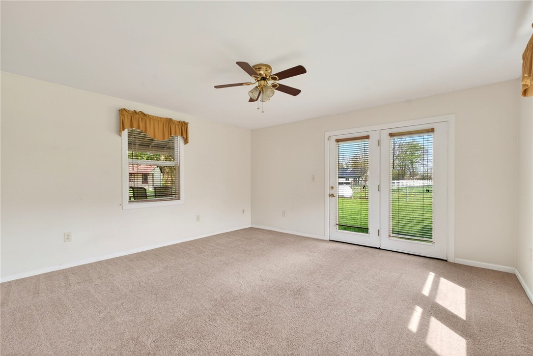7988 McCool Road Greenville, OH 45331 - Photo 12 of 50 This bright bedroom features direct outdoor access and ample natural light, creating a serene personal retreat.