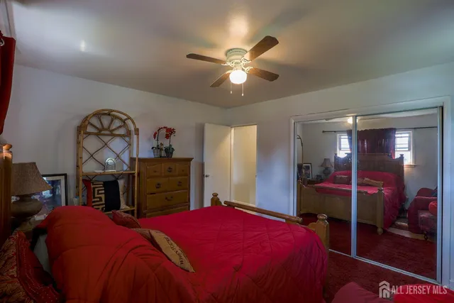 a bedroom with a bed and a mirror