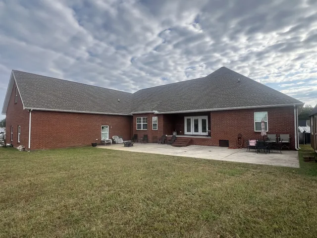 a house view with a sitting space and garden space