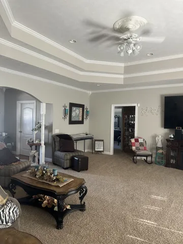 a living room with furniture and a chandelier