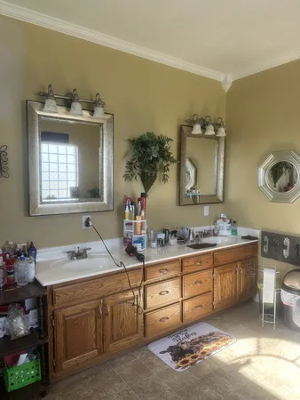 a en suite bathroom with a granite countertop sink and a mirror