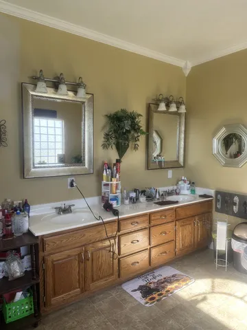 a en suite bathroom with a granite countertop sink and a mirror