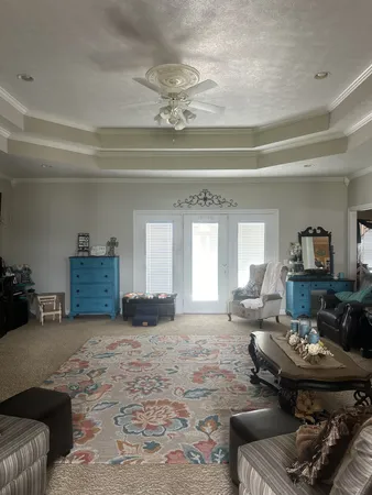 a living room with furniture and a chandelier