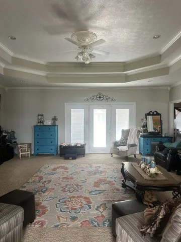 a living room with furniture and a chandelier