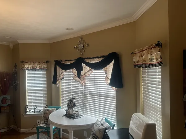 a dining room with furniture and window