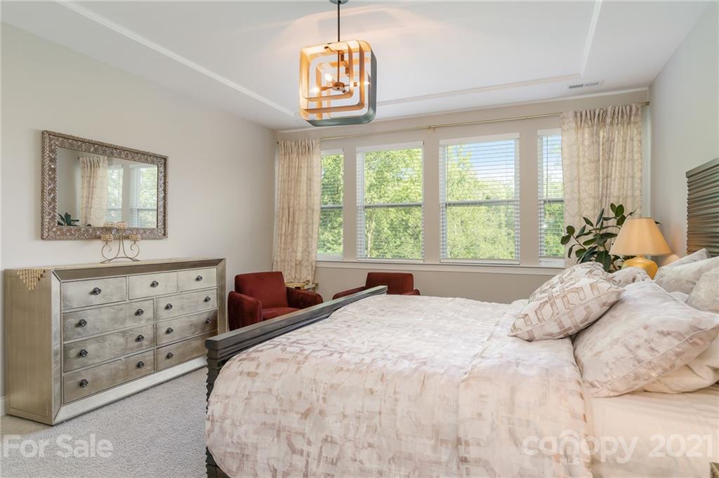 1342 Afton Way Fort Mill, SC 29708 - Photo 22 of 40 a bedroom with a bed a dresser and a window