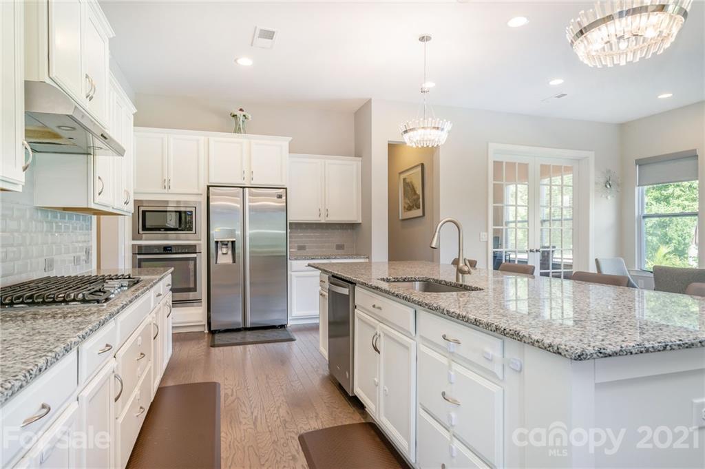 1342 Afton Way Fort Mill, SC 29708 - Photo 10 of 40 a kitchen with stainless steel appliances granite countertop a sink refrigerator and cabinets