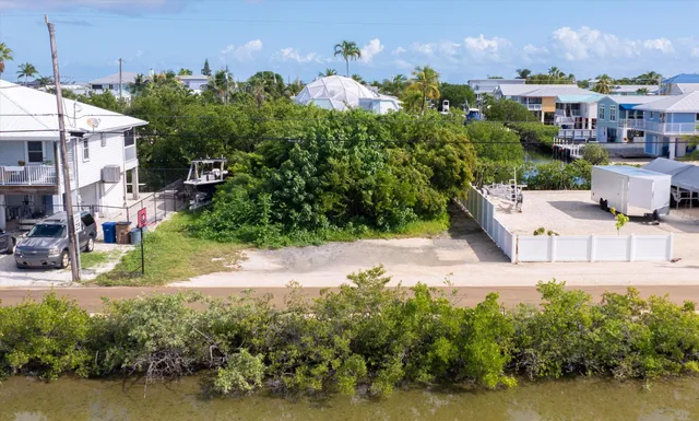 a view of a house with a yard and a pond