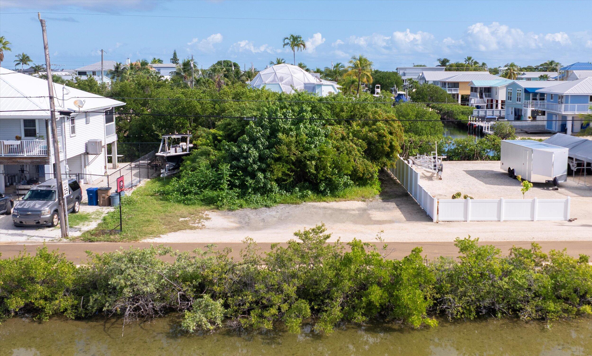a view of a house with a yard and a pond