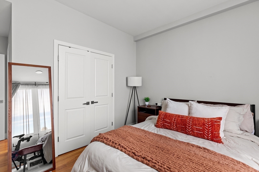 10 Taber Street, Unit 508 Boston, MA 02119 - Photo 9 of 11 a bedroom with a bed and a window