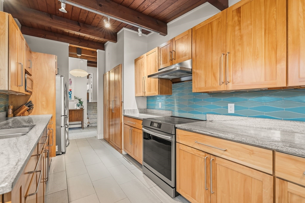 25 Rockwood Road Hingham, MA 02043 - Photo 12 of 32 a kitchen with stainless steel appliances granite countertop a sink and cabinets