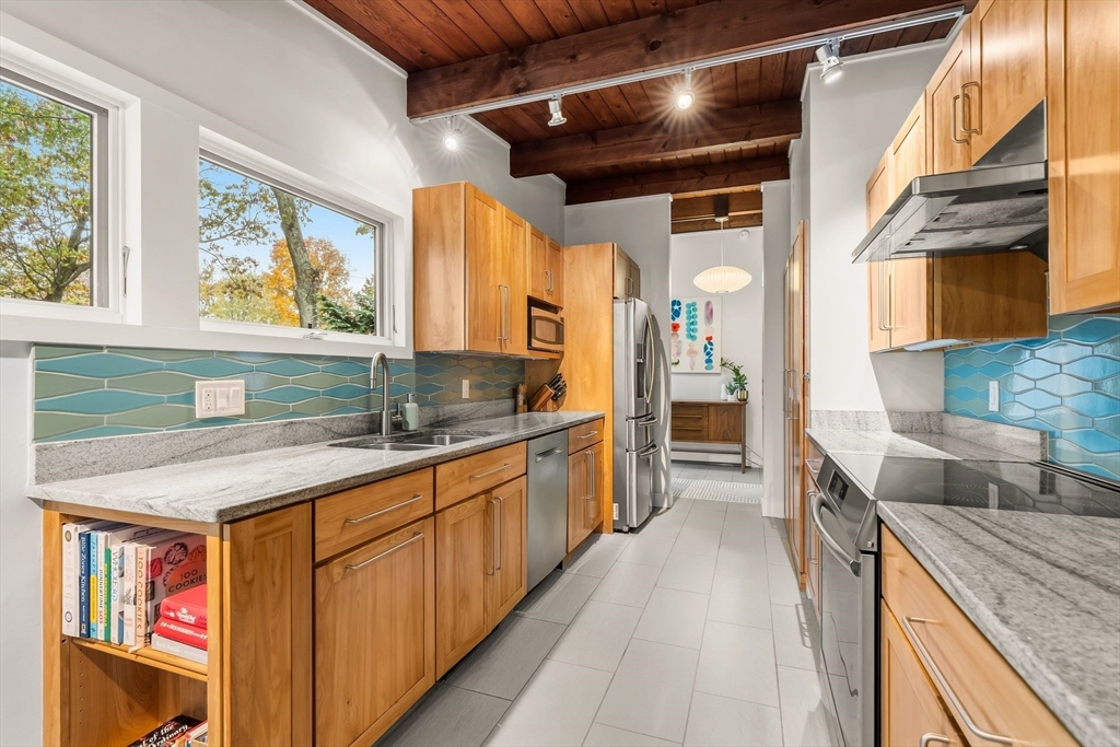 25 Rockwood Road Hingham, MA 02043 - Photo 13 of 32 a kitchen with stainless steel appliances granite countertop lots of counter top space and wooden floor
