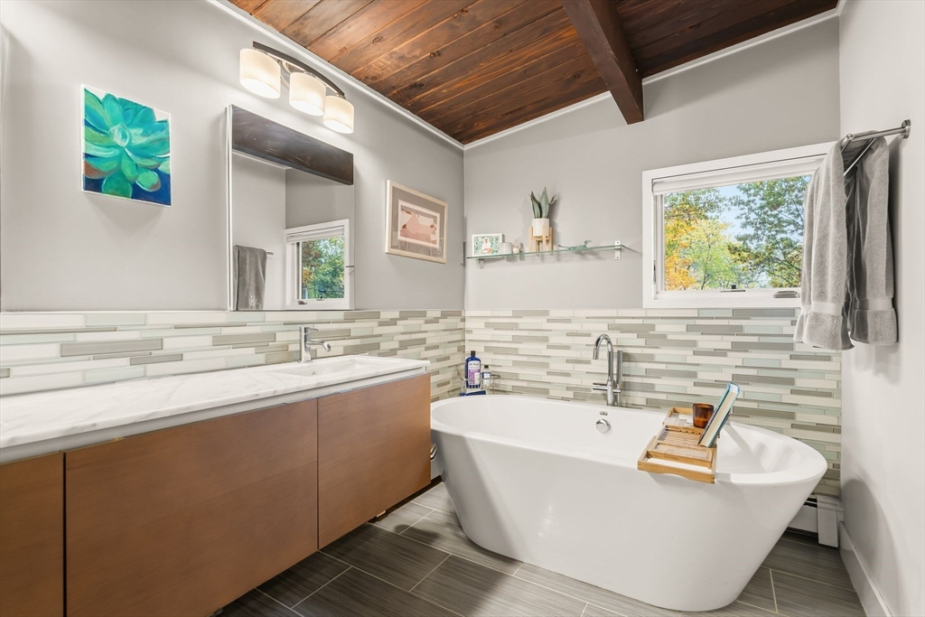 25 Rockwood Road Hingham, MA 02043 - Photo 19 of 32 a bathroom with a tub a sink and a window