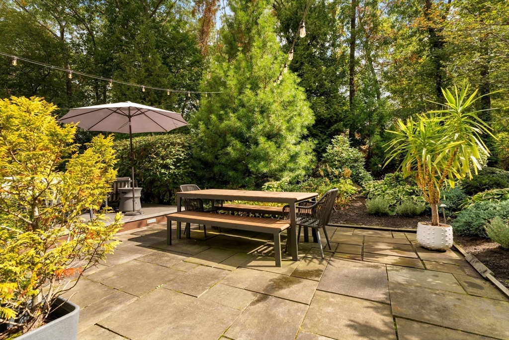 25 Rockwood Road Hingham, MA 02043 - Photo 30 of 32 a view of a patio with a table and chairs under an umbrella
