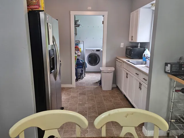 a bathroom with a granite countertop toilet sink and mirror