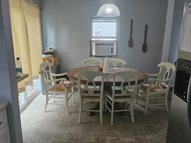 a view of a dining room with furniture and window