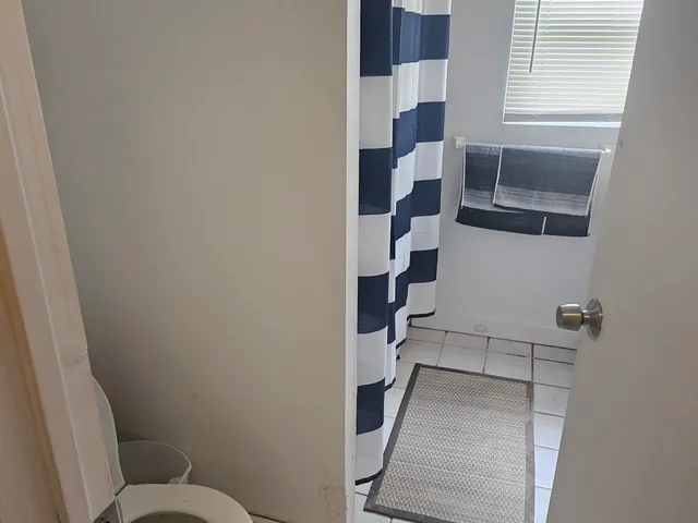 a bathroom with a toilet a sink and a mirror