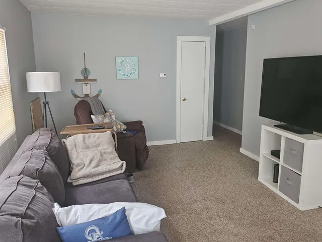 a bedroom with furniture and a flat screen tv