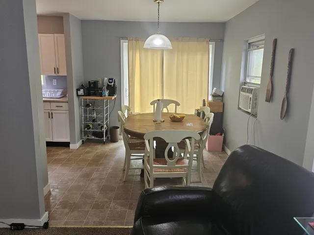 a dining room with furniture and window