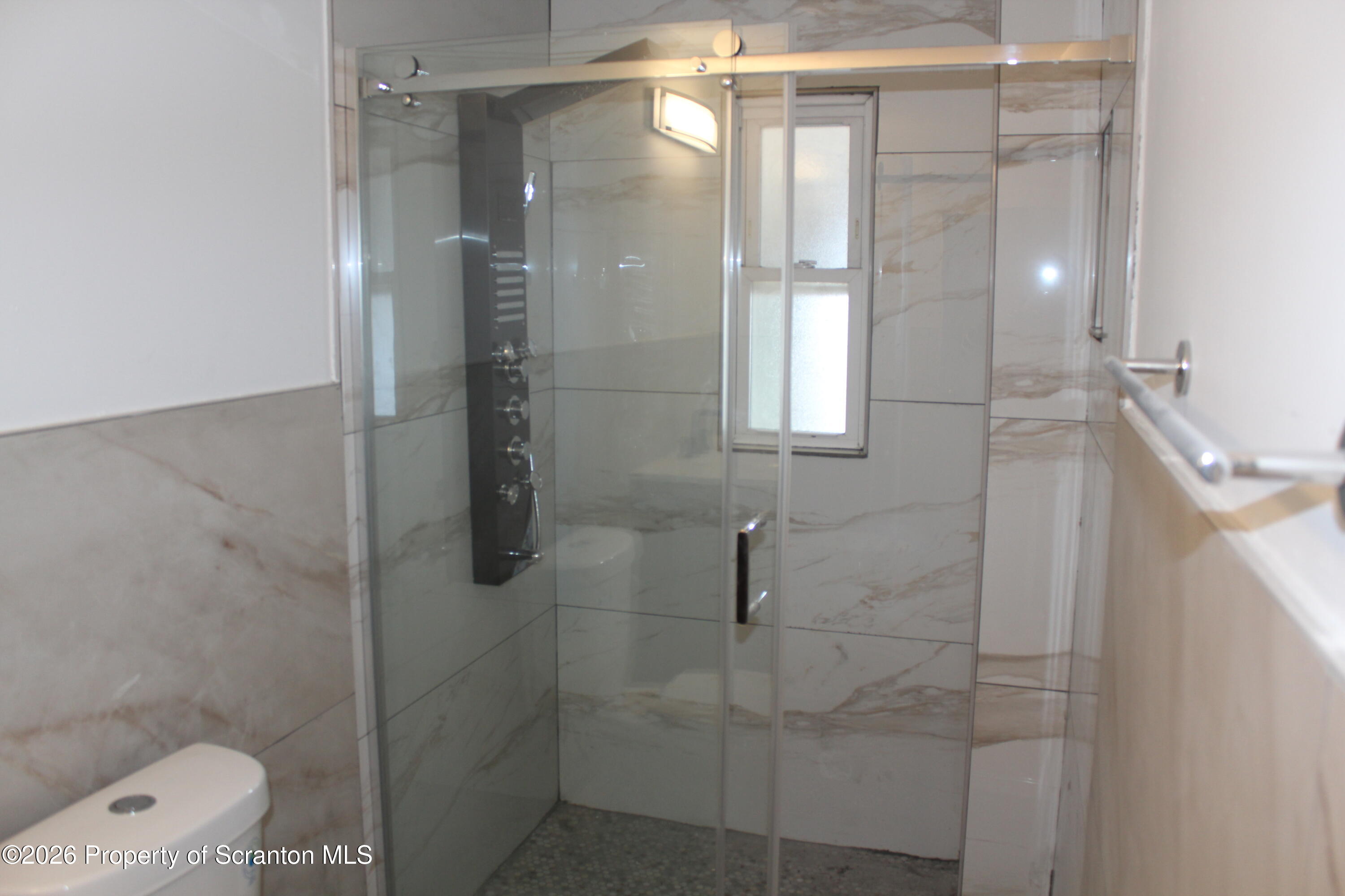 335 Phelps Street, Unit 3 Scranton, PA 18509 - Photo 11 of 15 a bathroom with a shower and toilet