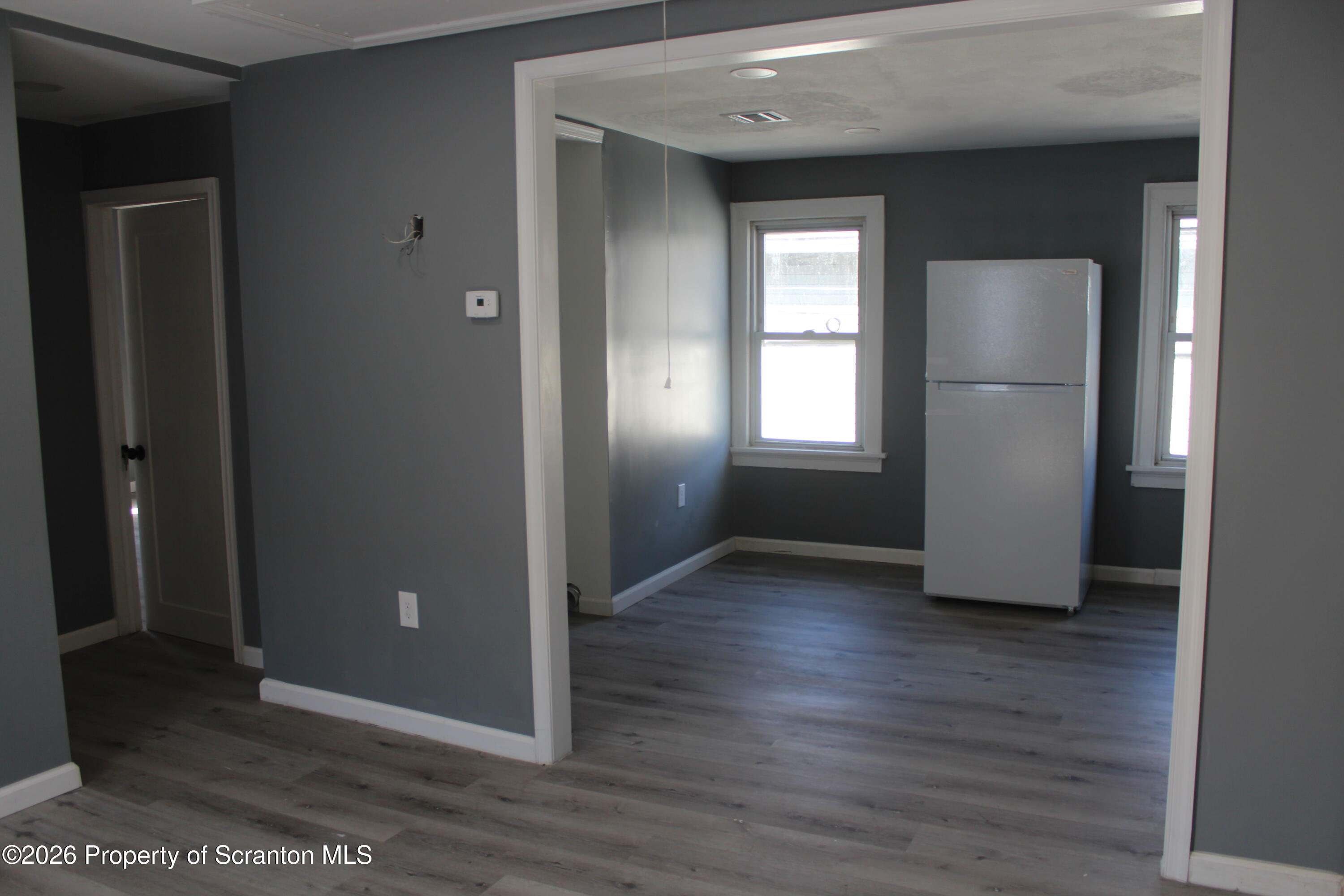 335 Phelps Street, Unit 3 Scranton, PA 18509 - Photo 5 of 15 an empty room with wooden floor and windows