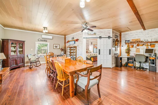 a dining room with a wooden table and chairs