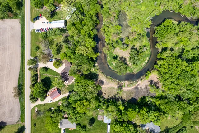 an aerial view of a house with a yard and garden