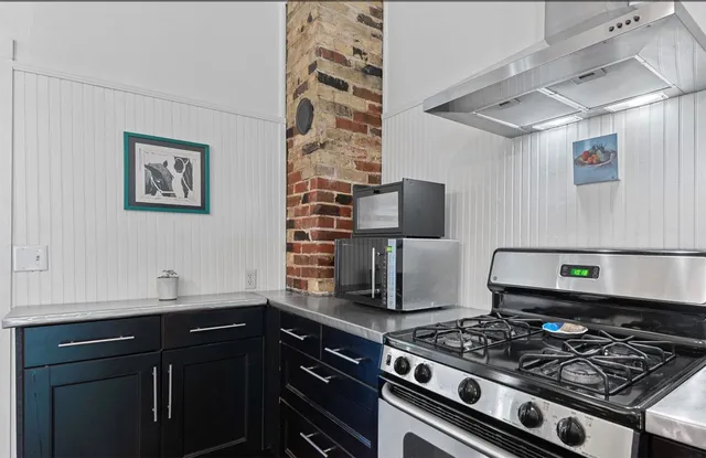 a kitchen with stainless steel appliances granite countertop a stove and a sink